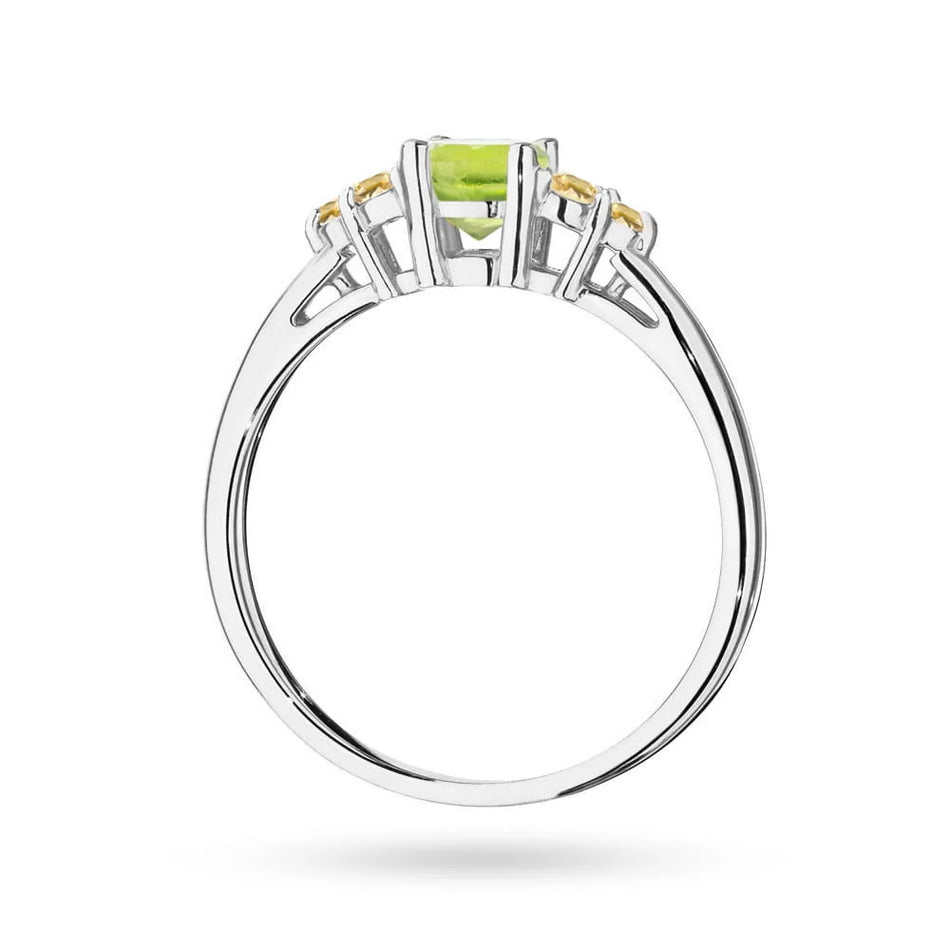 Prsteň z bieleho zlata 14k(585) s olivínom 0,60 ct a 6 bronzovými diamantmi. Perfektný ako darček.