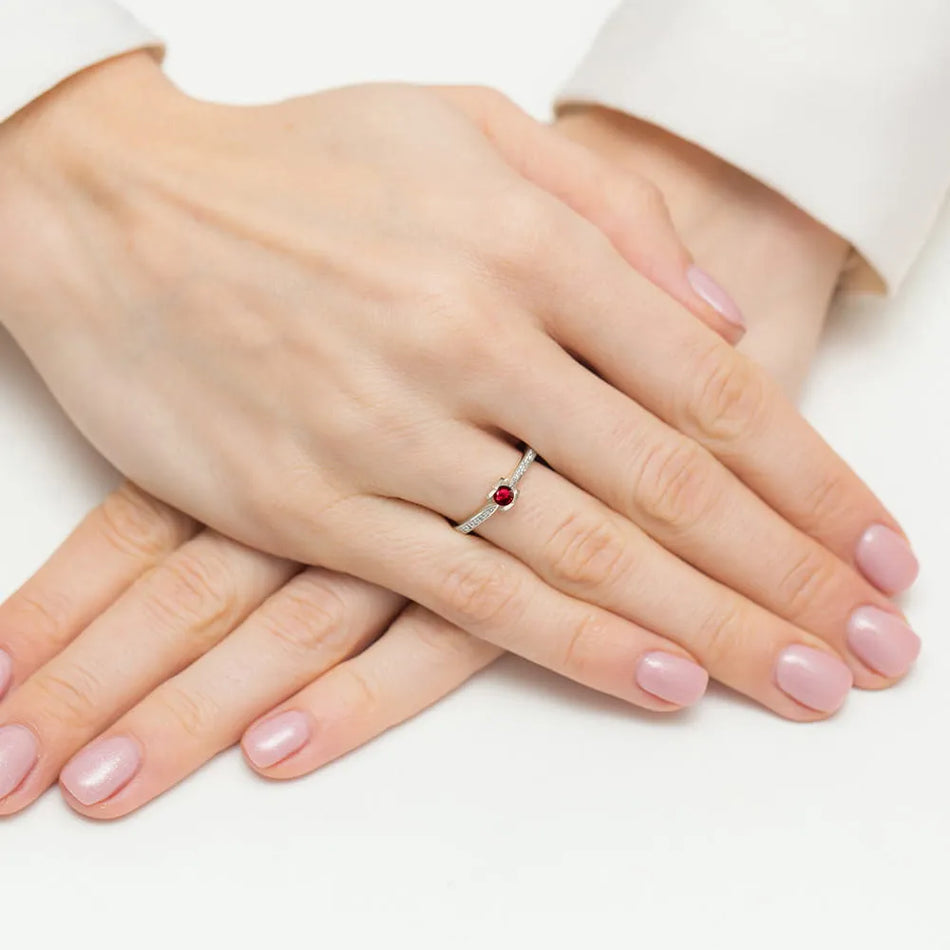 14k white gold ring with 0.15ct ruby and 0.05ct diamonds. Packed in black box, paper and gift bag.